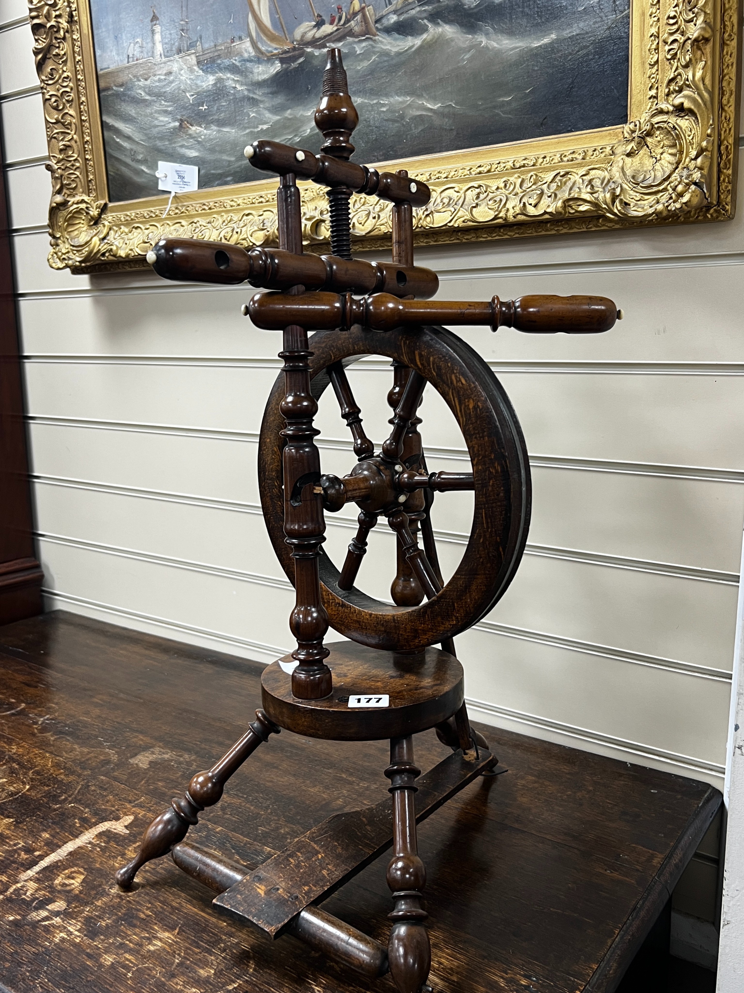 A provincial mahogany and beech spinning wheel, height 67cm